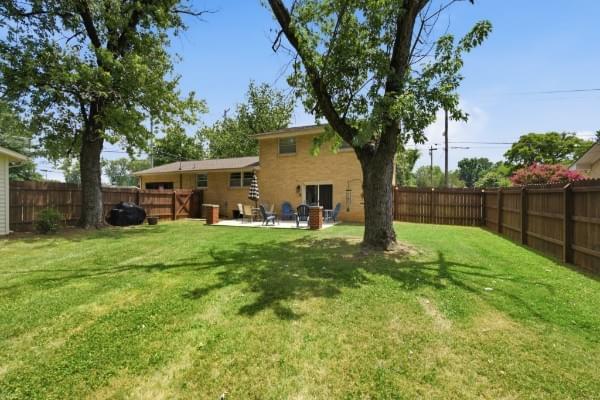 Fenced backyard with mature shade tree and privacy fencing at 1002 W Northfield Blvd Forest Hills Estates Murfreesboro TN