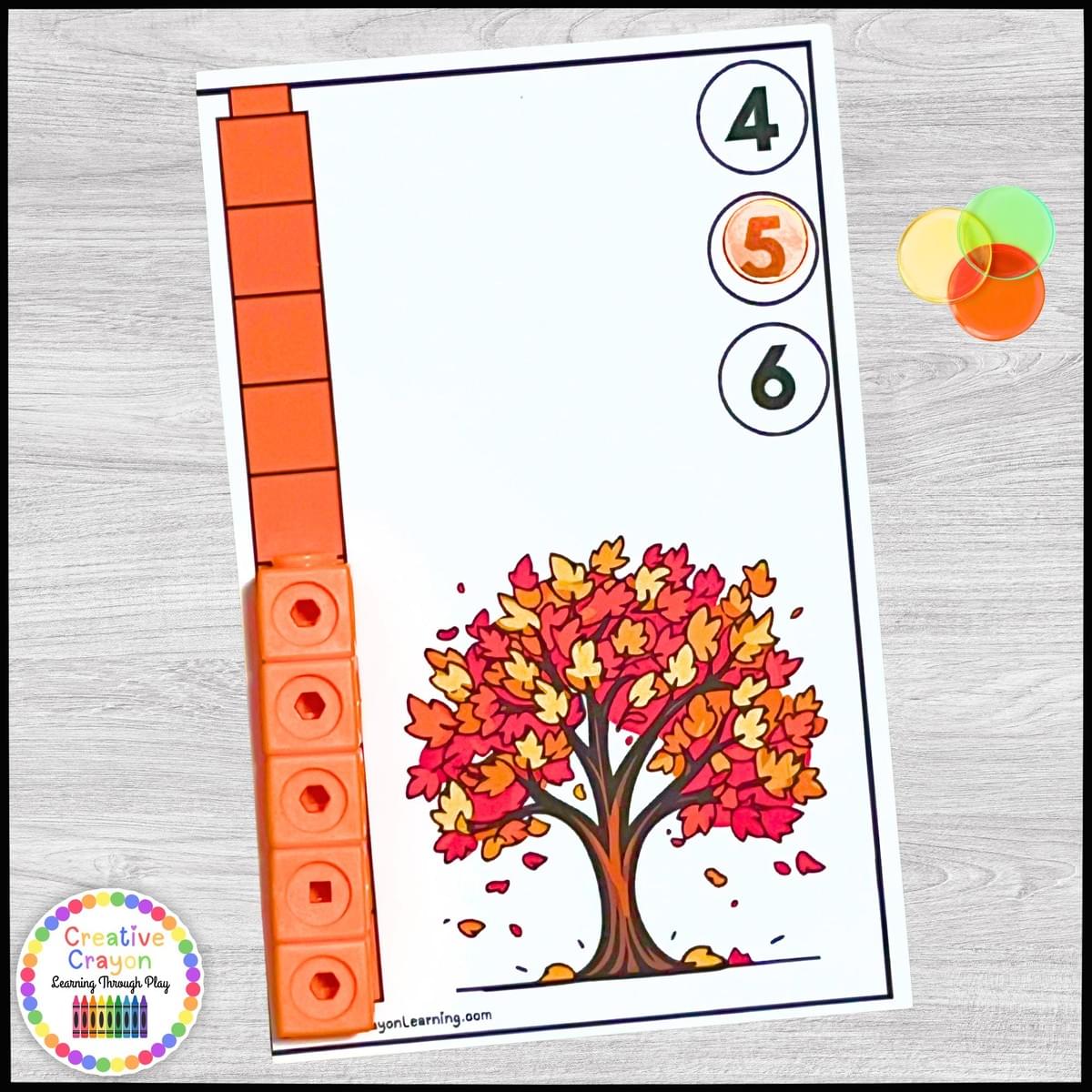 Fall-themed measurement center for kindergarten with math link cubes and seasonal character cards.
