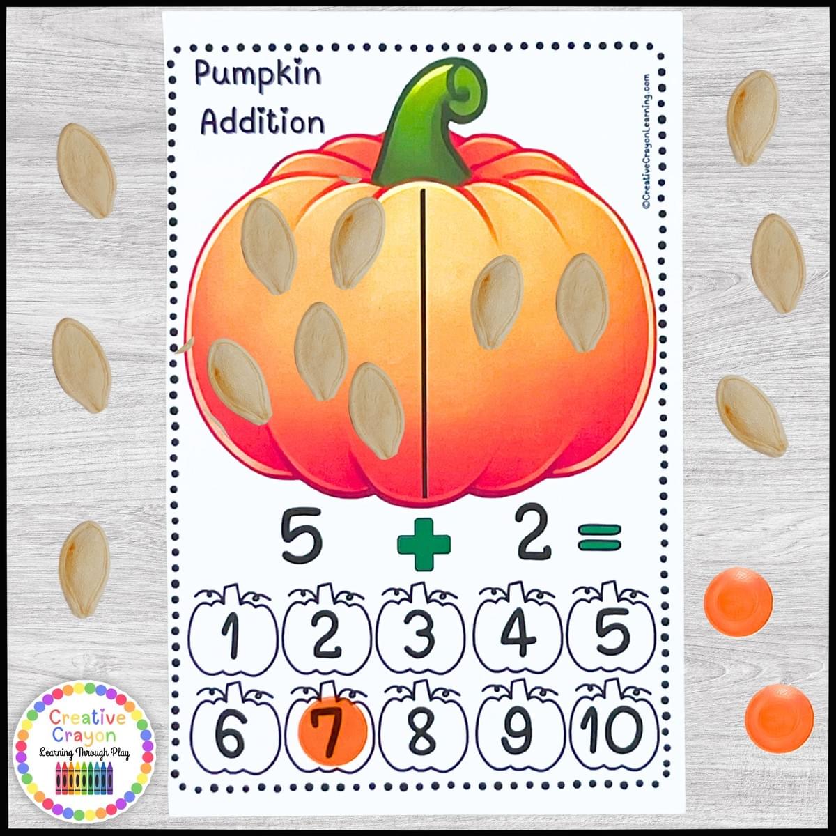 Pumpkin-themed addition math center for kindergarten with fall counting cards, manipulatives, and hands-on addition practice.