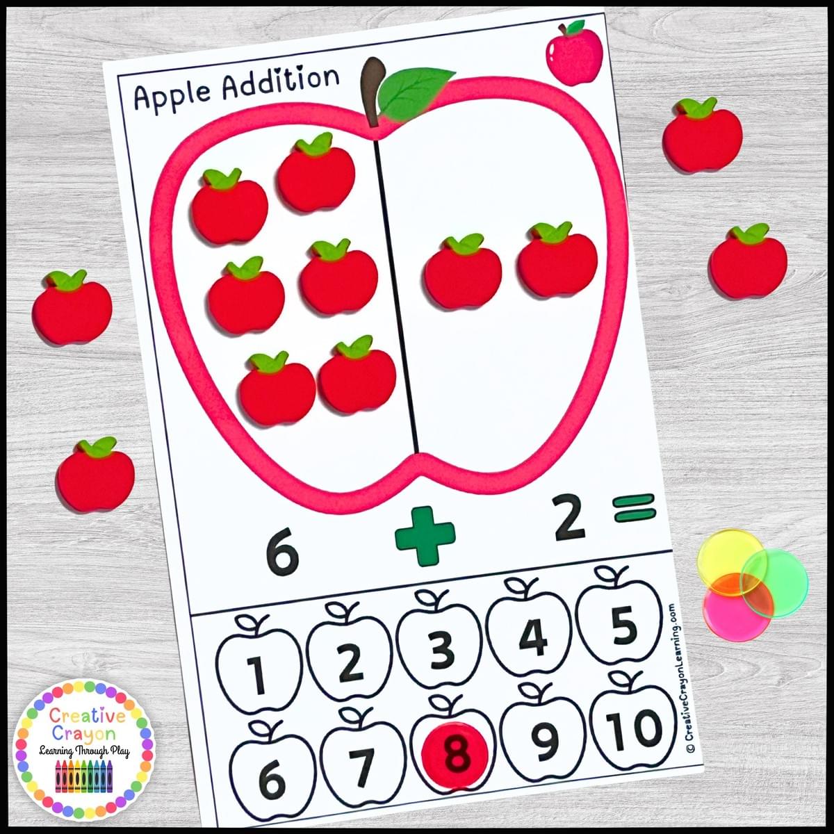 Apple-themed hands-on addition math center for kindergarten with apple erasers and counting practice to 10.