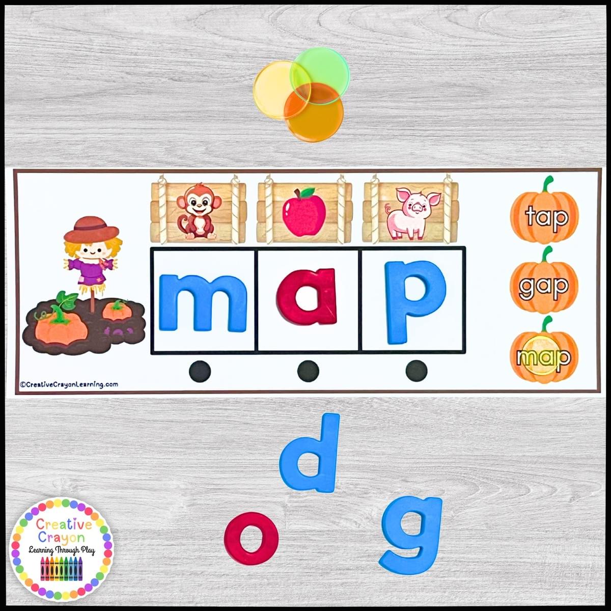 Pumpkin-themed CVC word building literacy center for kindergarten with picture sound clues and word boxes.