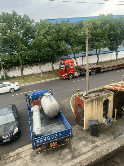 Technicians securing the exchanger on the truck bed for safe delivery.