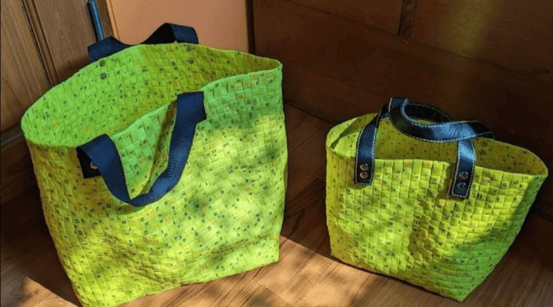 A couple of bright yellow totes woven out of manufacturing waste.