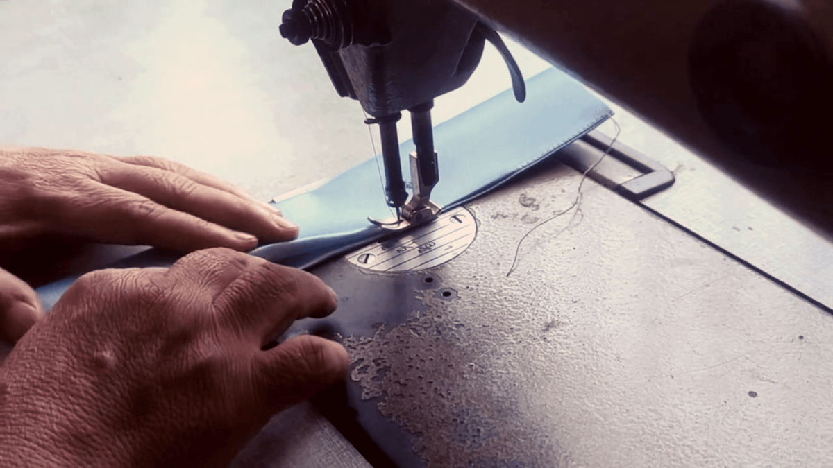 An informal seamstress in Bangkok sews a strap for a Morph bag.