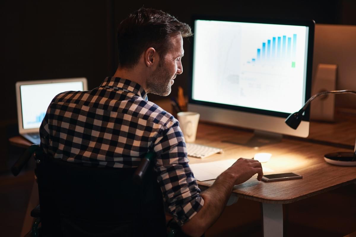 Digital marketing professional analyzing SEO performance charts on laptop to improve Google rankings and AI search visibility