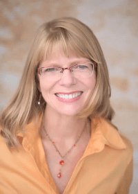 Tina, caring professional, offering a comforting touch during a therapeutic massage, helping clients reduce stress and enhance relaxation.