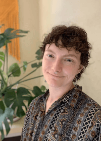 Quinn, Licensed Massage Therapist, using gentle touch to administer craniosacral therapy on a patient, fostering relaxation and healing through mindful bodywork.