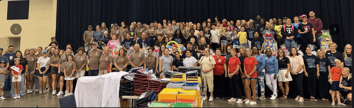A great success for the back-to-school bash. Group photo of all partners that came together to put on the event for the community.