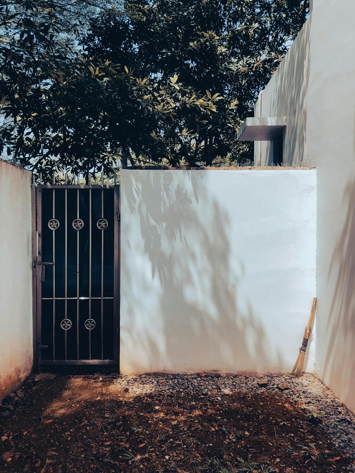 White block wall with custom iron gate in alley entrance of home in Avondale Az