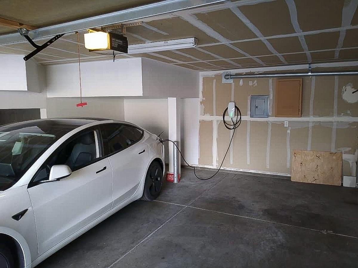 Residential EV Charger In Garage Plugged Up To Car