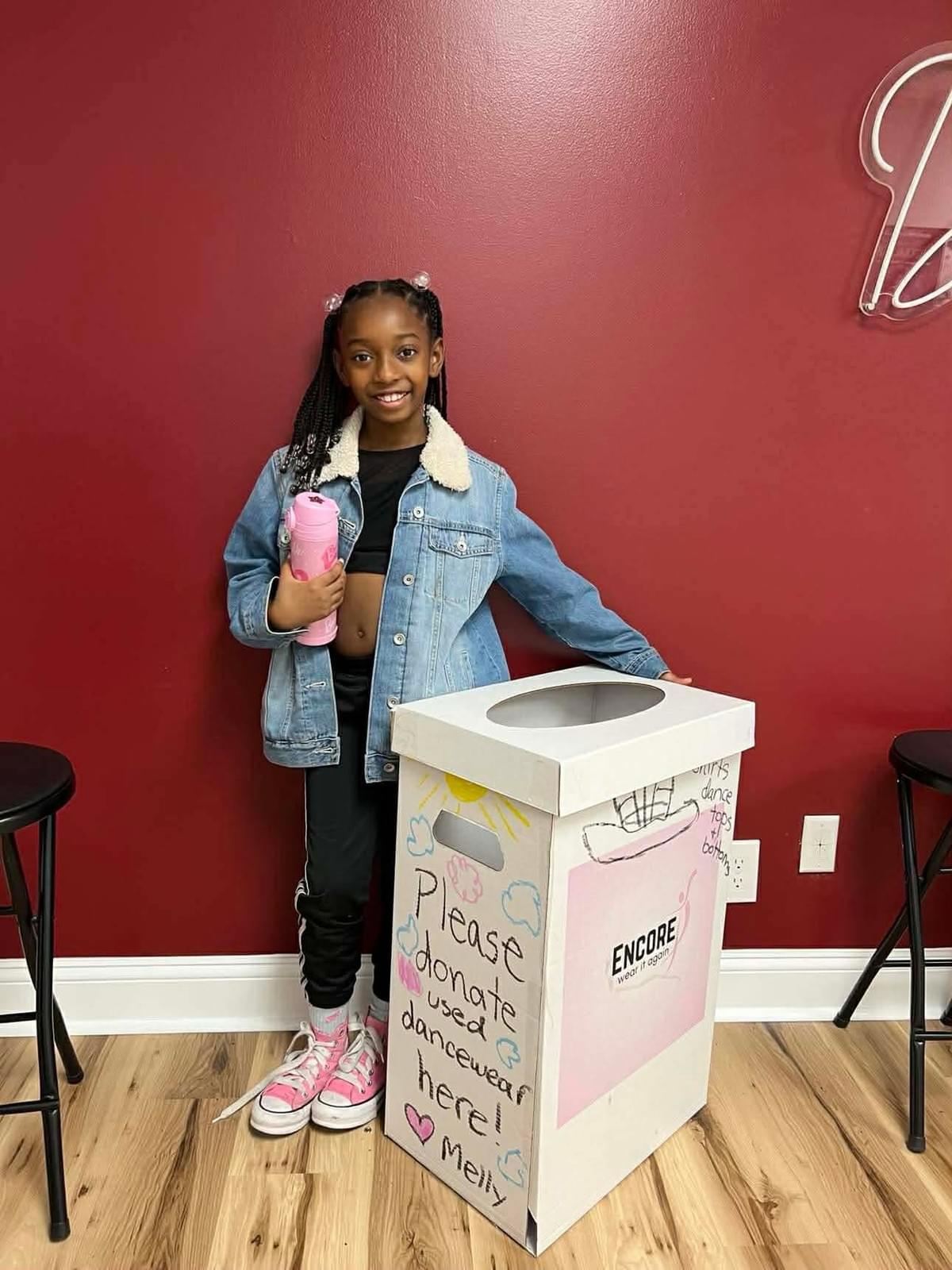 At Encore, we believe in the power of community and sharing. Our initiative not only provides gently used dancewear to those in need but also promotes sustainability by reducing waste. Every donation helps a dancer continue their passion without the financial burden of new gear. Community Impact What We Do What is Encore?
Encore is a community service initiative started by June Ella Hyams when she was in the 6th grade.  Beautifully designed donation boxes are housed at dance studios throughout the Charleston, South Carolina area.  Lightly used or new dancewear, athletic wear, and shoes are donated to the boxes, and once the box is near full, we collect, clean, and ship the items to those in need.

How did Encore begin?
June Ella noticed that she was growing quickly out of her new dancewear and her mother noticed she had even outgrown some dancewear that still had tags on them before she got the chance to wear them.  This became the idea of sharing these clothes with other dancers.  Dancewear can be expensive, so this program helps to ease the financial burden for growing dancers as well as putting the dancewear back into good use for their own "encore".
