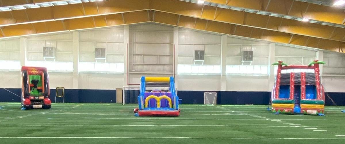 Bounce house and inflatable water slide rentals set up for backyard in Wolverine Lake, Michigan
