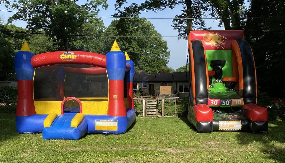 Bounce house and inflatable water slide rentals set up for backyard in Bloomfield Village Michigan