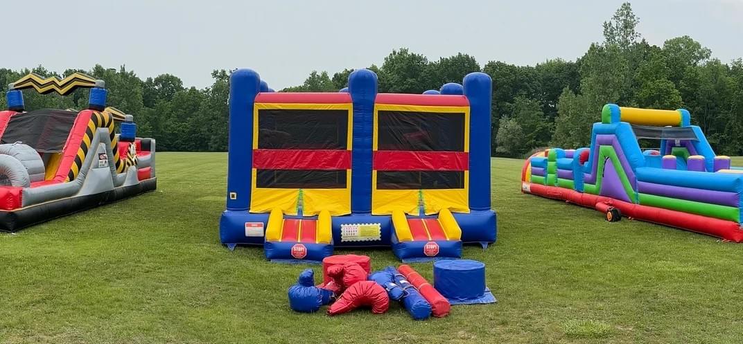 Bounce house and inflatable water slide rentals set up for backyard in Madison Heights Michigan