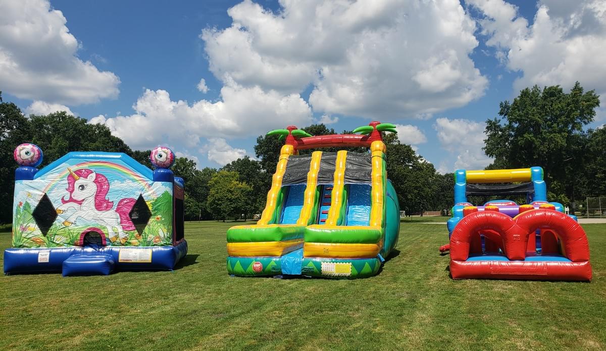 Bounce house and inflatable water slide rentals set up for backyard in Berkley Michigan