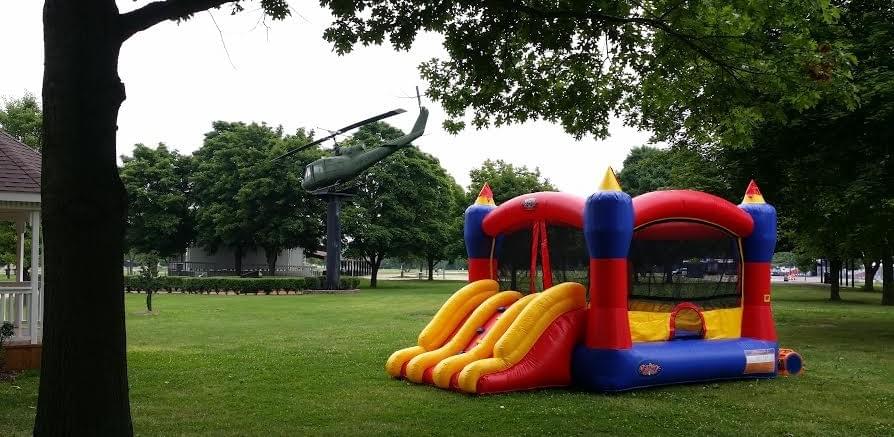Bounce house and inflatable water slide rentals set up for backyard in Waterford, Michigan