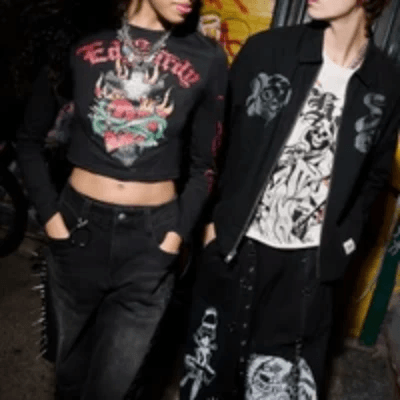 Two models in black Ed Hardy graphic tops and pants with skull and heart tattoo-style designs.