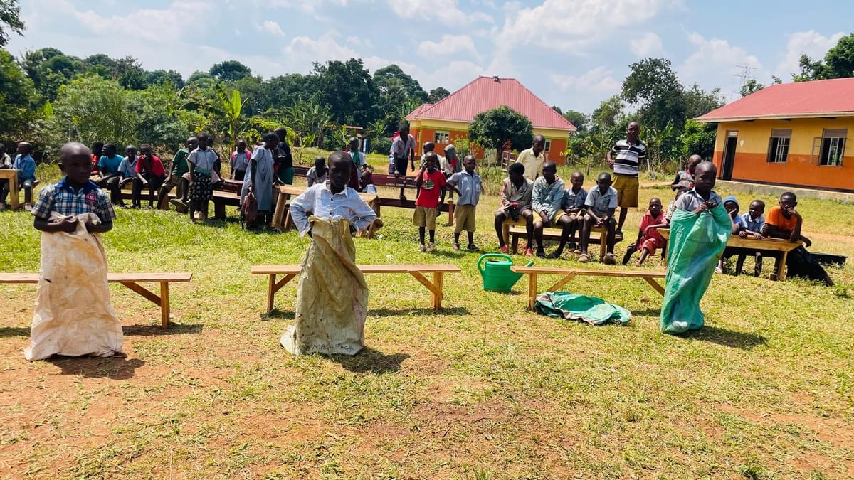 The learners competing in a sack race.