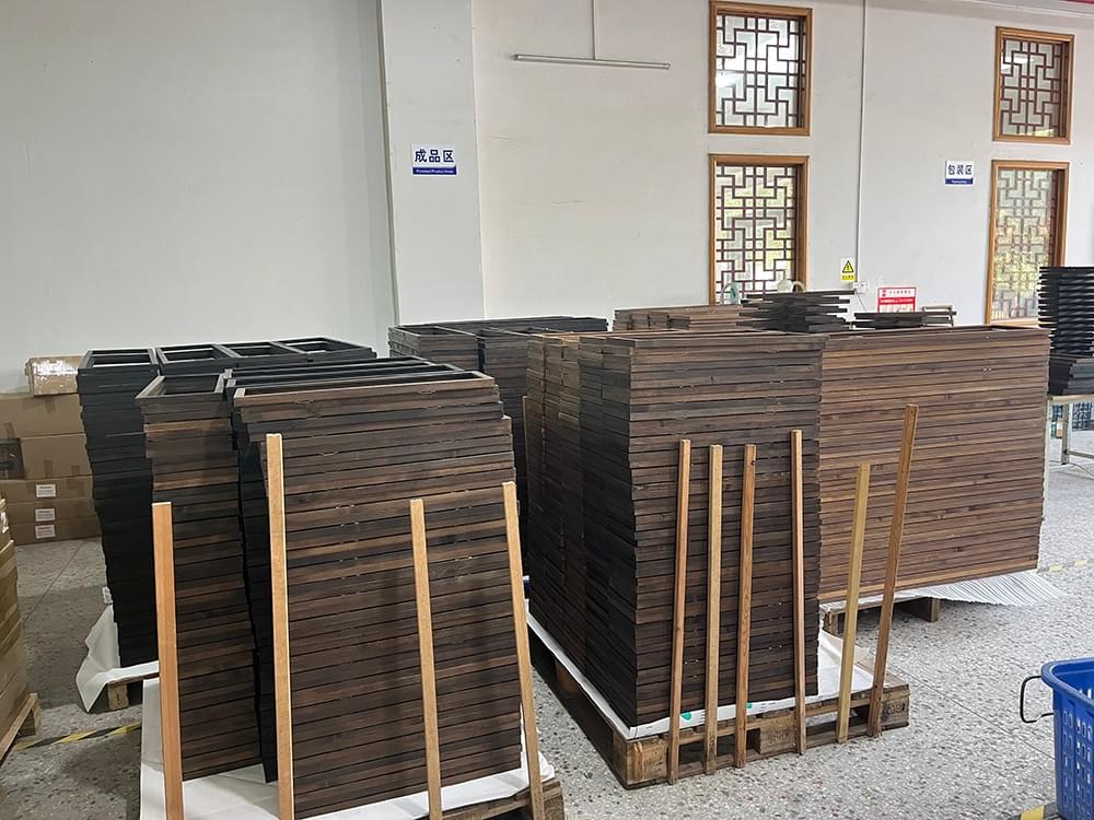 Bulk dark-finished wood sign frames organized in Honfar’s production workshop