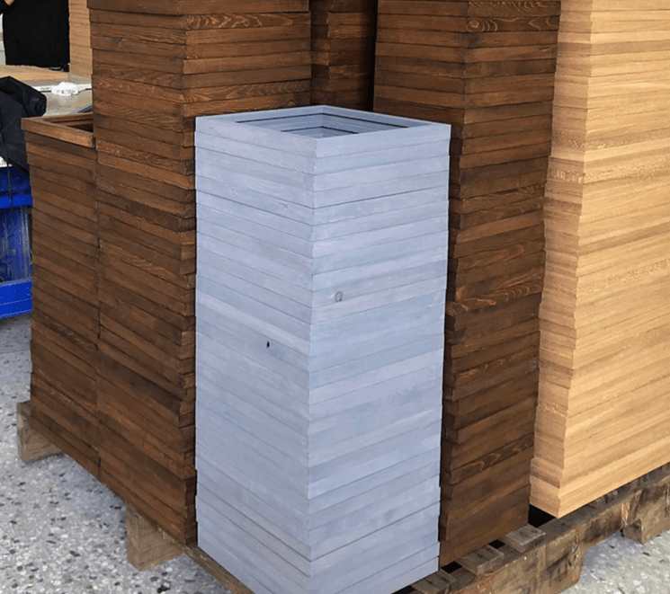 Unfinished and stained wood sign blanks stacked for custom production