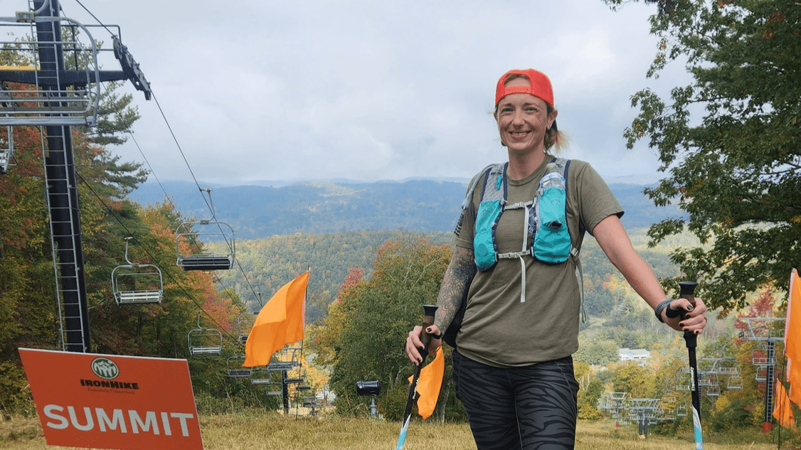 Hannah Brauchle at the IronHike summit sign on Mohawk Mountain