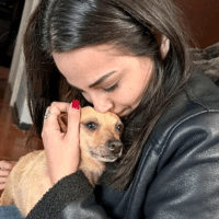 Adopter cuddling a newly rescued dog in its forever home.