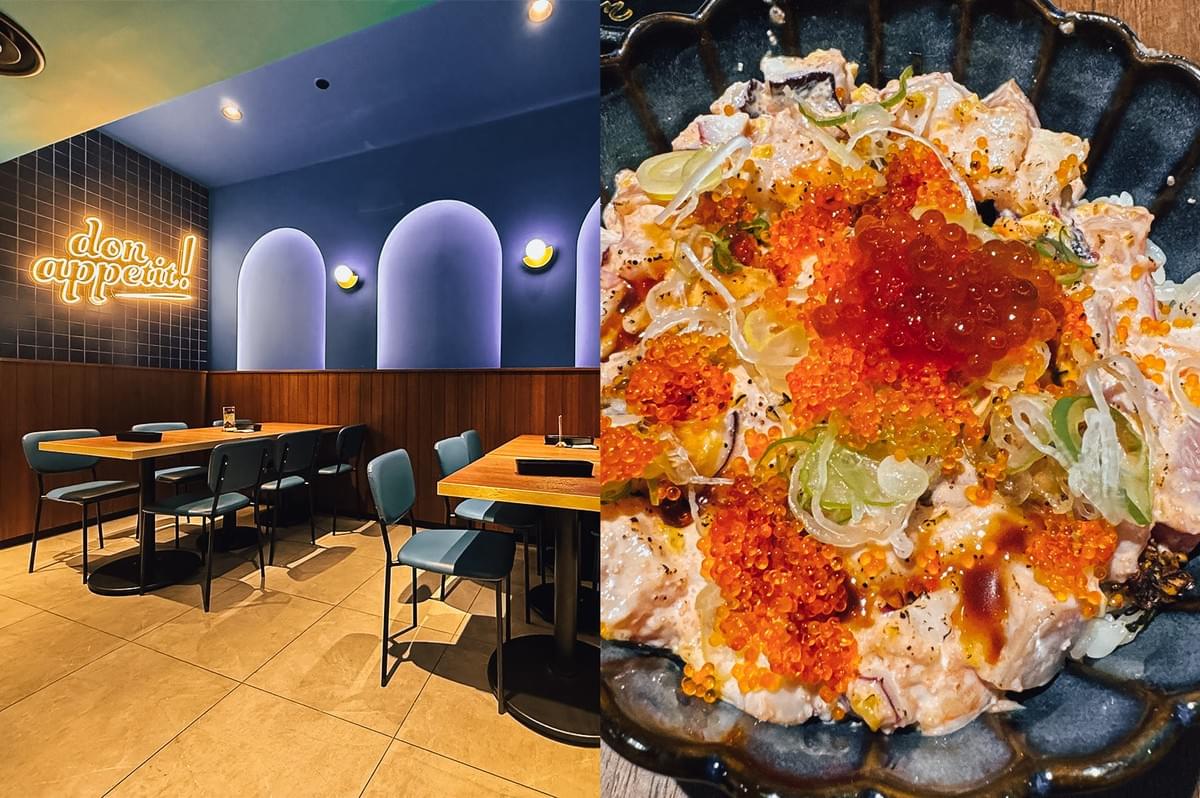 “Left: Wide-angle, eye-level view of a modern restaurant interior with blue walls, arched recessed wall features, warm wall sconces, a glowing ‘bon appetit!’ neon sign on dark tiled walls, wooden tables, upholstered chairs, and large beige floor tiles under ambient lighting. Right: Close-up, top-down view of a chirashi don bowl in a dark scalloped ceramic dish, topped with diced seafood, bright orange fish roe, red salmon roe, sliced scallions, sauce drizzles, and white rice, highlighting glossy textures and vibrant color contrast.”