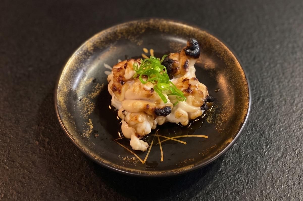 A plate of food on a black surface.
