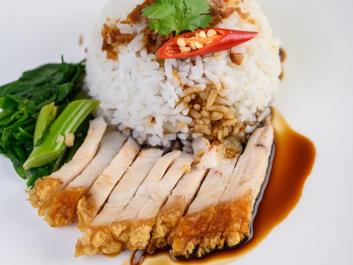 An overhead shot of a chicken rice dish presented in a fantastic way.