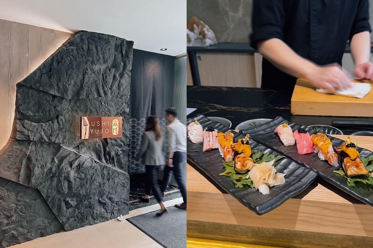 eft:Exterior view of a modern Japanese restaurant entrance. A backlit, rough-textured dark stone feature wall bears a rectangular wooden sign that reads "SUSHI YUJO" alongside Japanese kanji characters. To the right of the stone wall is a doorway partially covered by a long navy blue noren curtain with a wave-like pattern along the bottom. right: A chef in a black uniform stands behind a wooden counter wiping their hands. In the foreground sit two matching long, textured black ceramic plates, each displaying an identical row of five high-end nigiri sushi pieces. The toppings include sliced white fish, tuna garnished with caviar, cooked sweet shrimp, and seared unagi topped with uni (sea urchin) and edible gold leaf, alongside pickled ginger and wasabi.