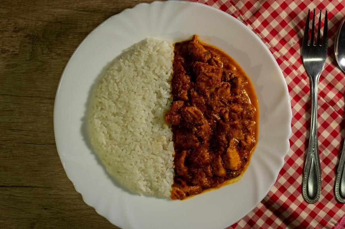 A plate of chicken curry accompanied by rice, representing cherished food memories.