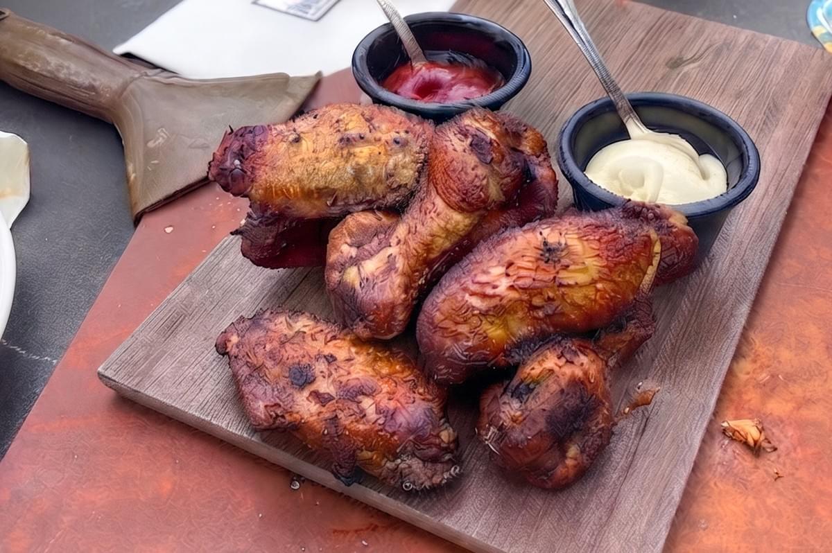 Grilled chicken wings with dipping sauces served at Dallas Cafe and Bar at Marina Bay Sands.
