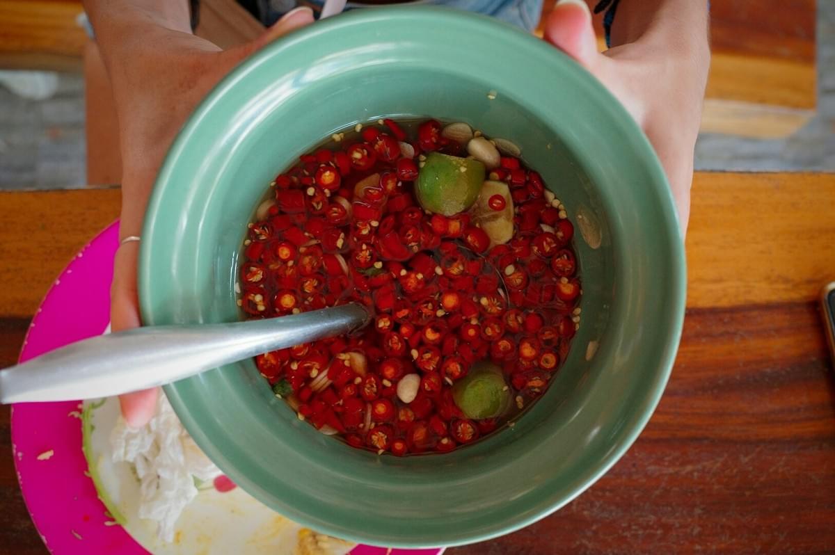 A person poised with a spoon above a bowl of food, illustrating the role of food culture in bridging generational gaps.