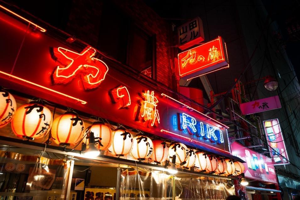 An image of a Chinese restaurant as it glows in the night hours of Singapore with its signature red neon lights.