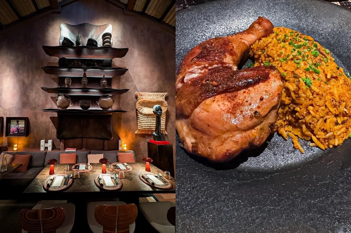 Left: An eye-level, wide-angle interior shot of an upscale restaurant dining room decorated with African art, showcasing a long wooden table set for a meal with woven placemats, small red table lamps, a dark sofa booth with accent pillows, and a prominent wall display featuring tiered shelves lined with tribal pottery and sculptures under soft spotlights. Right: A top-down, close-up culinary shot of a roasted chicken quarter with crispy seasoned skin served alongside a mound of savory, orange-tinted jollof rice garnished with chopped green chives on a textured matte black plate.