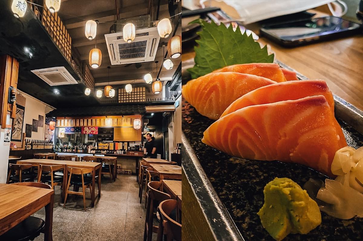 Left: Wide-angle eye-level view of a traditional Japanese izakaya dining space with wooden tables and chairs, warm hanging paper lanterns, exposed ceiling beams, and a bar counter lined with bottles and small menu boards in the background. Right: Close-up, top-down angle of salmon sashimi slices arranged on a dark ceramic plate with visible marbling, accompanied by a green shiso leaf, wasabi, and pickled ginger on a wooden table.