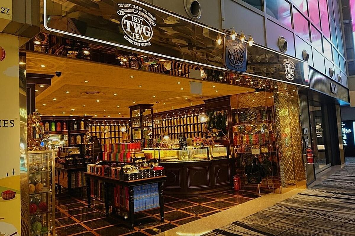 Exterior view of TWG Tea in Singapore featuring a large sign above the entrance.