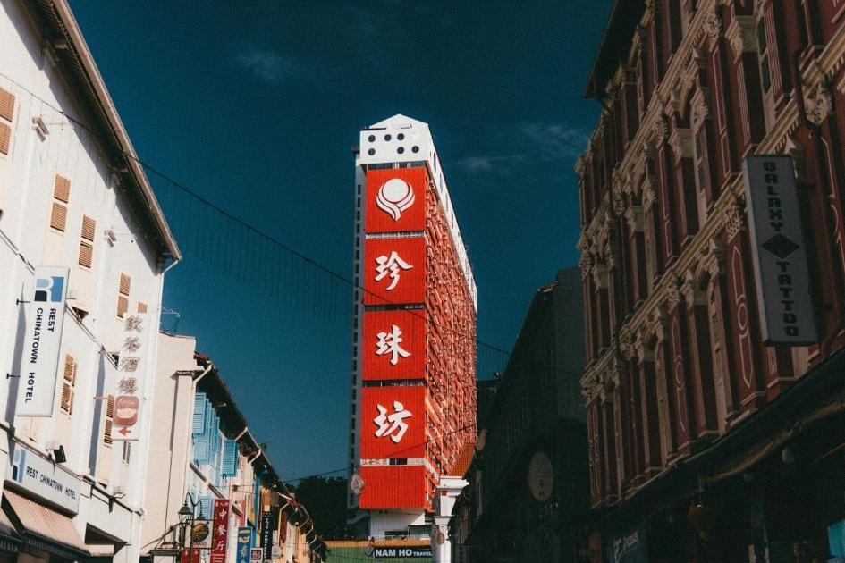 A photo of a vibrant red infrastructure in Singapore's Chinatown as it basks towards the evening hours.