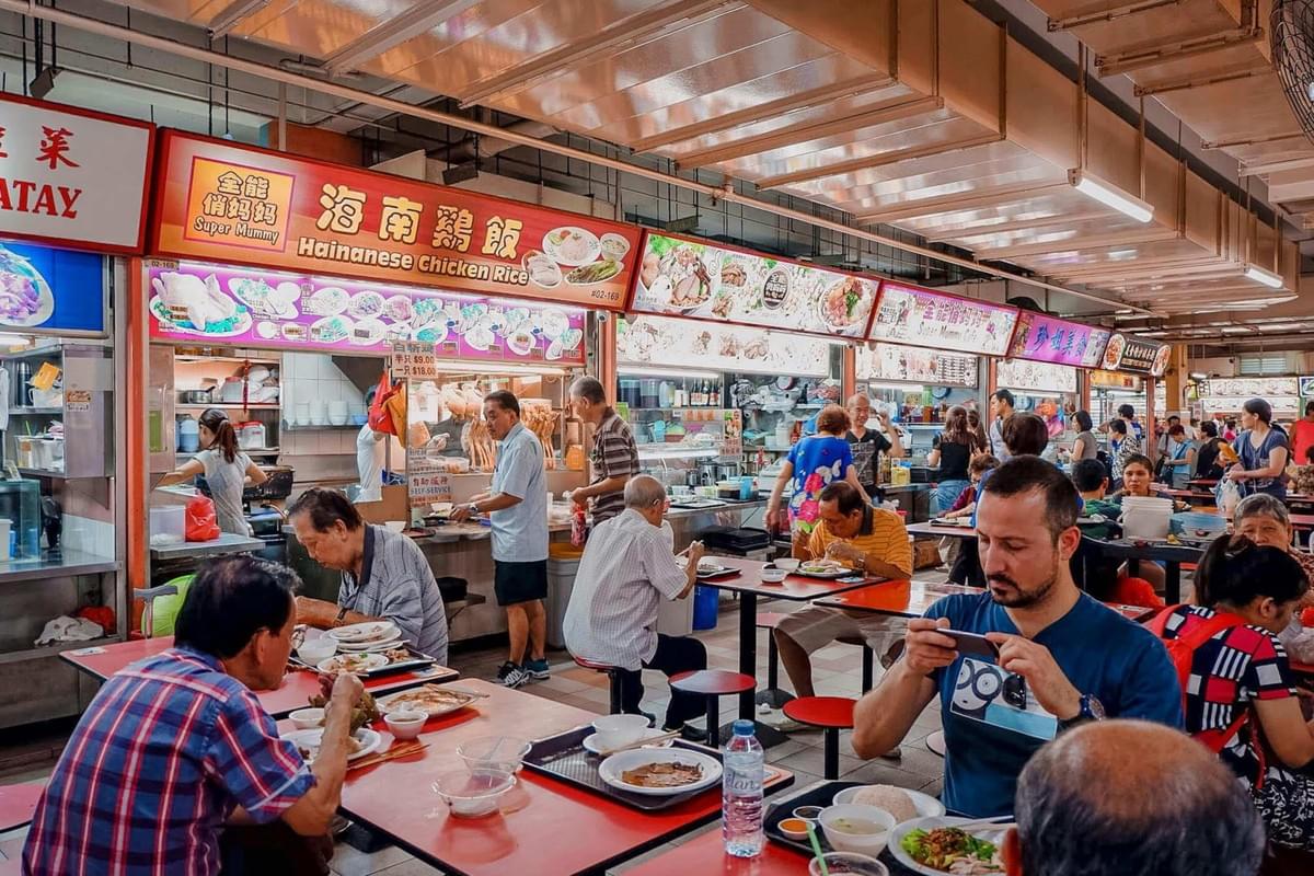 Hawker food center, emphasizing its sense of community as people eat together.