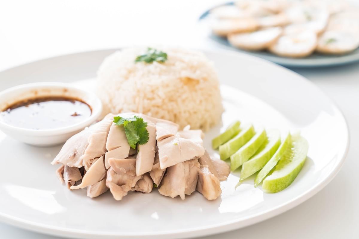 AN aesthetically photographed plate of chicken rice dish.