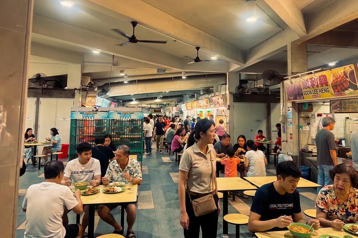 Crowded indoor seating area at ABC Brickworks Market and Food Centre in Singapore.