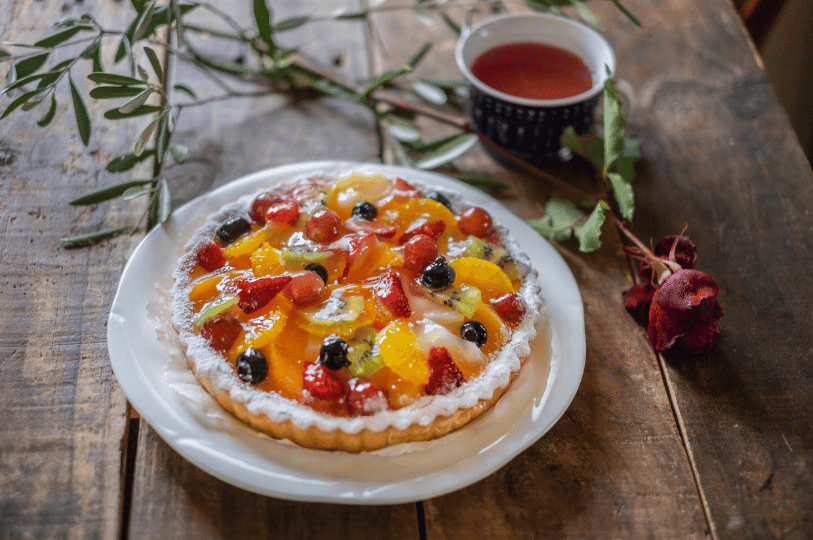 A stack of rich chocolate brownies drizzled with syrup and sprinkles, showcasing a dense, fudgy texture ideal for comparing baking styles.