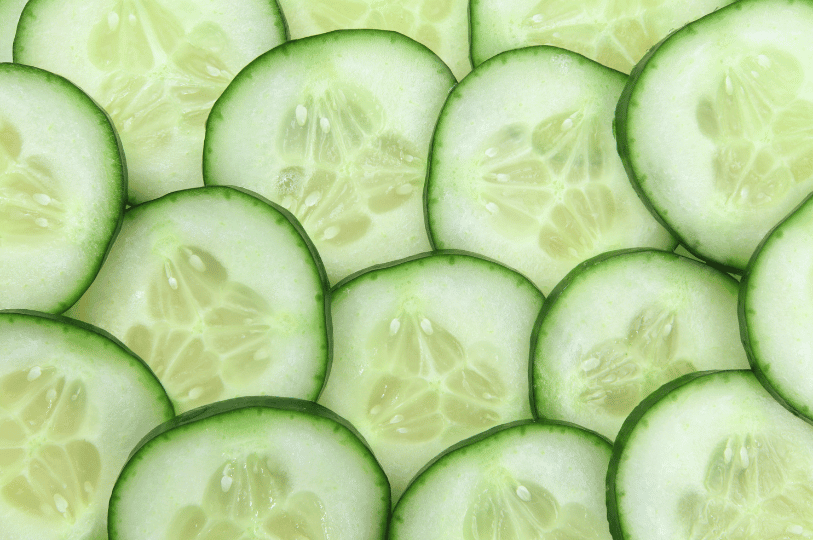 A bright, healthy summer salad in a white bowl, featuring chopped cucumbers, cherry tomatoes, and fresh herbs tossed in a light dressing.