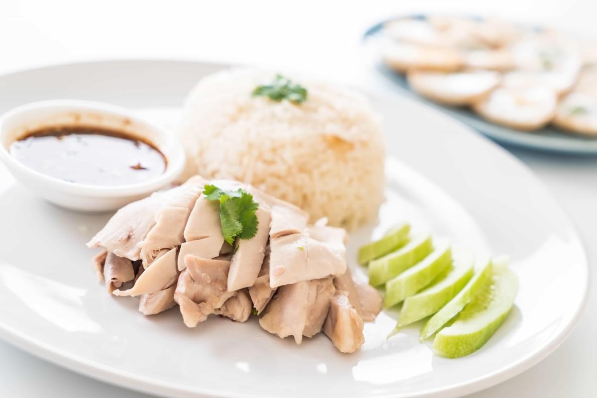 An aesthetically photographed Hainanese chicken rice with a white background.