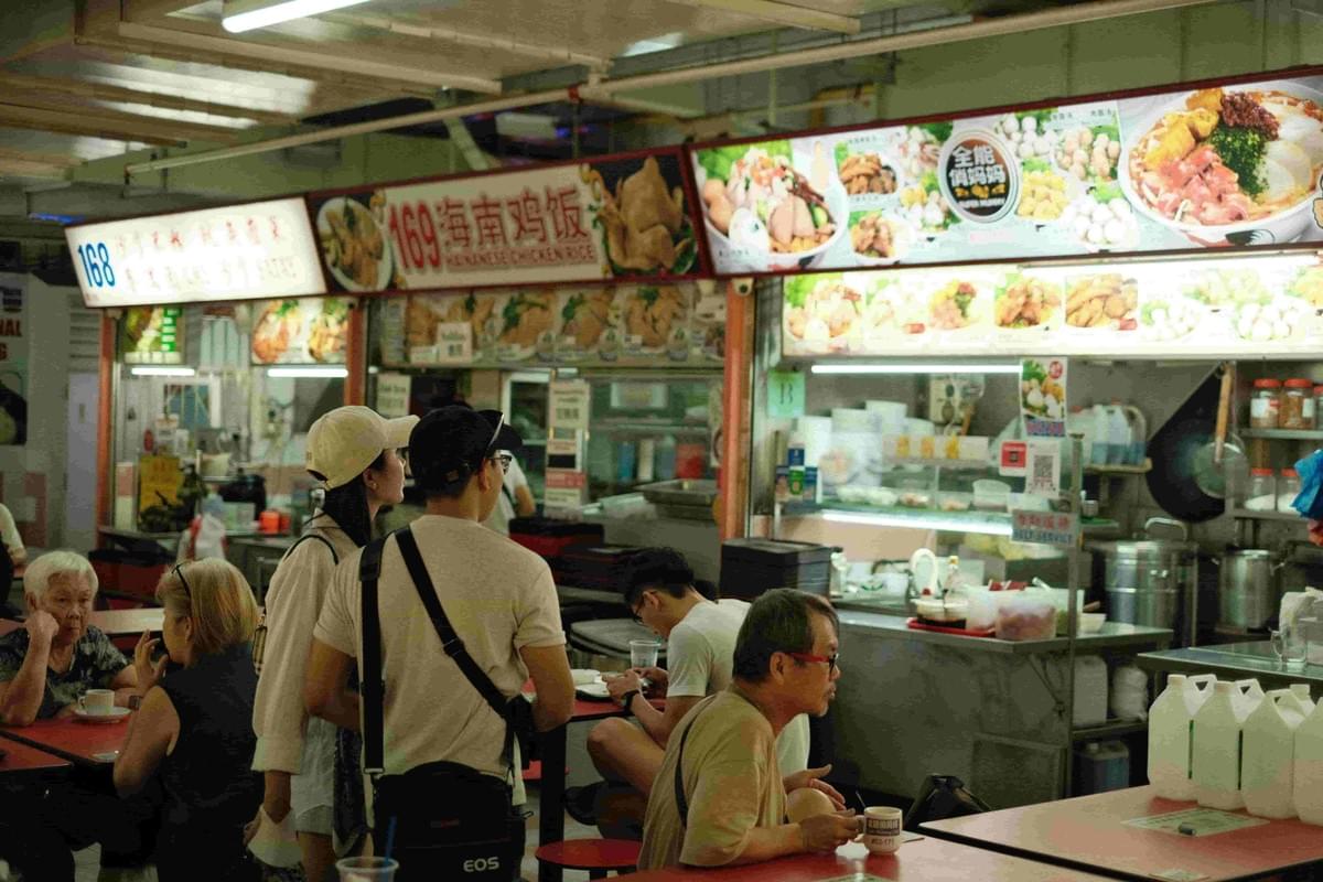 A busy hawker stall filled with hungry customers for some traditional dishes.