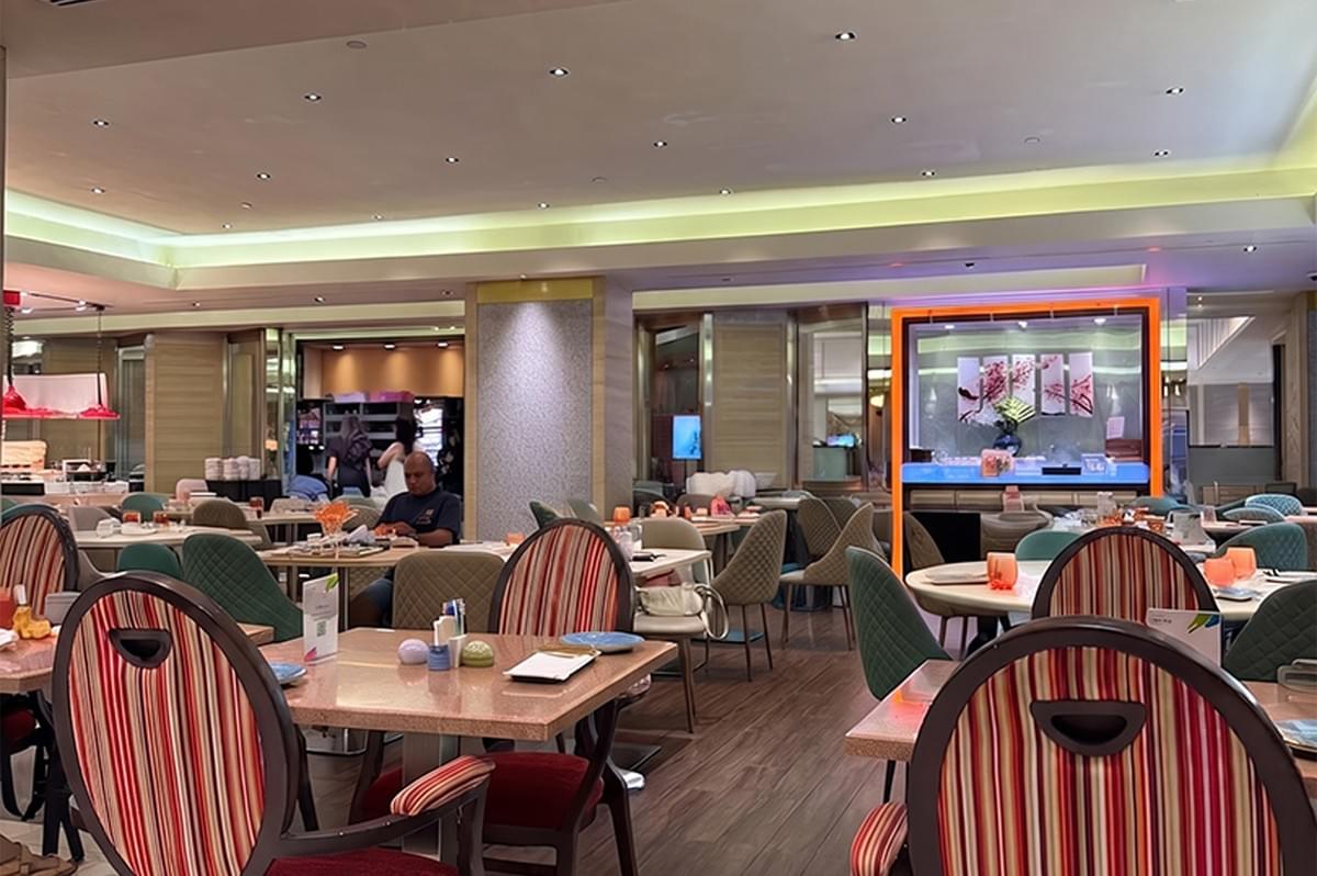 Interior dining area of Carousel restaurant featuring tables and colorful striped chairs.