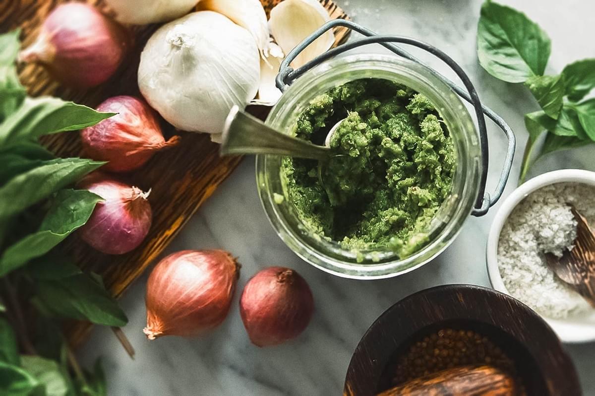 Fresh Thai ingredients including shallots, garlic, basil, and homemade green curry paste.
