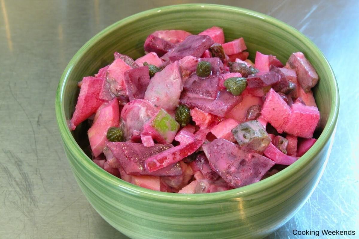 A colorful bowl of chopped red and green vegetables, featured in the Finnish Classic: Pickled Herring and Beet Salad.