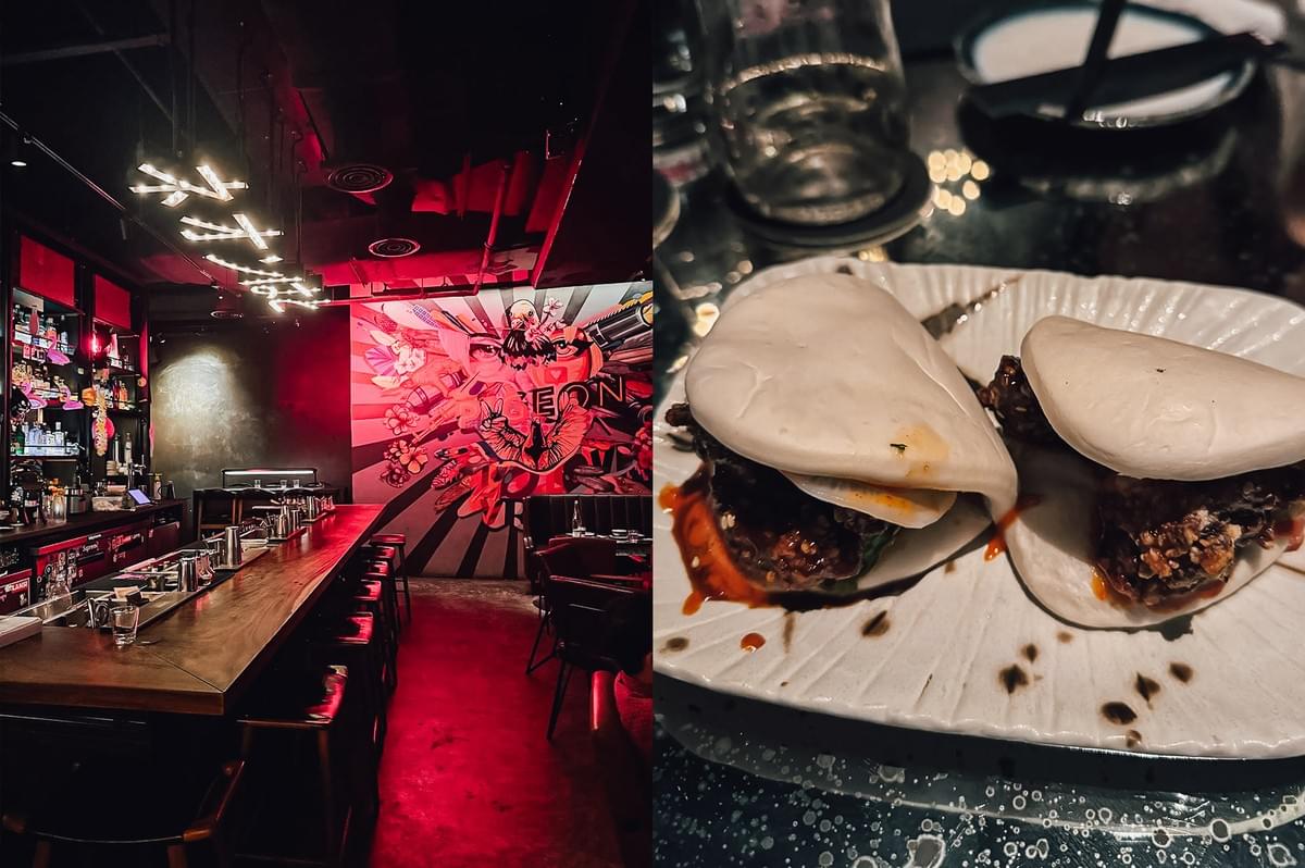 Left: Wide-angle eye-level shot of a dimly lit izakaya bar interior with a long wooden counter, backlit shelves of liquor bottles, red accent lighting, and a large mural artwork creating a vibrant nightlife atmosphere. Right: Close-up, three-quarter angle of two soft bao buns filled with glazed meat and sauce, served on a textured plate with visible drips and glossy highlights under low, moody lighting.