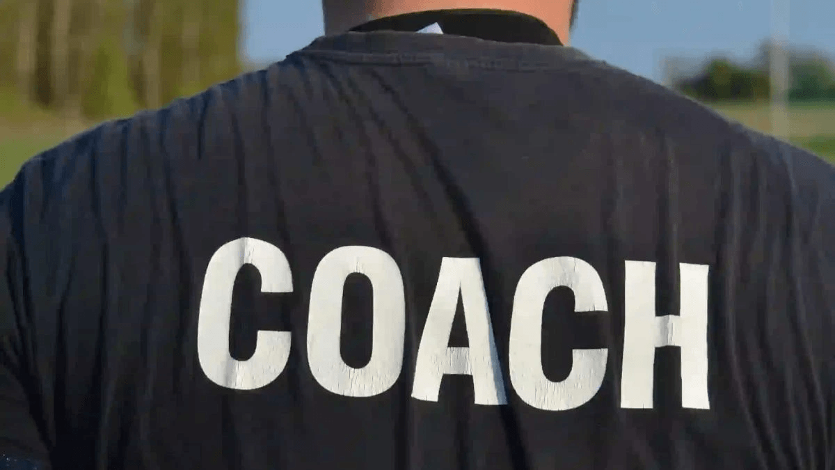 A coach leading a youth baseball team.